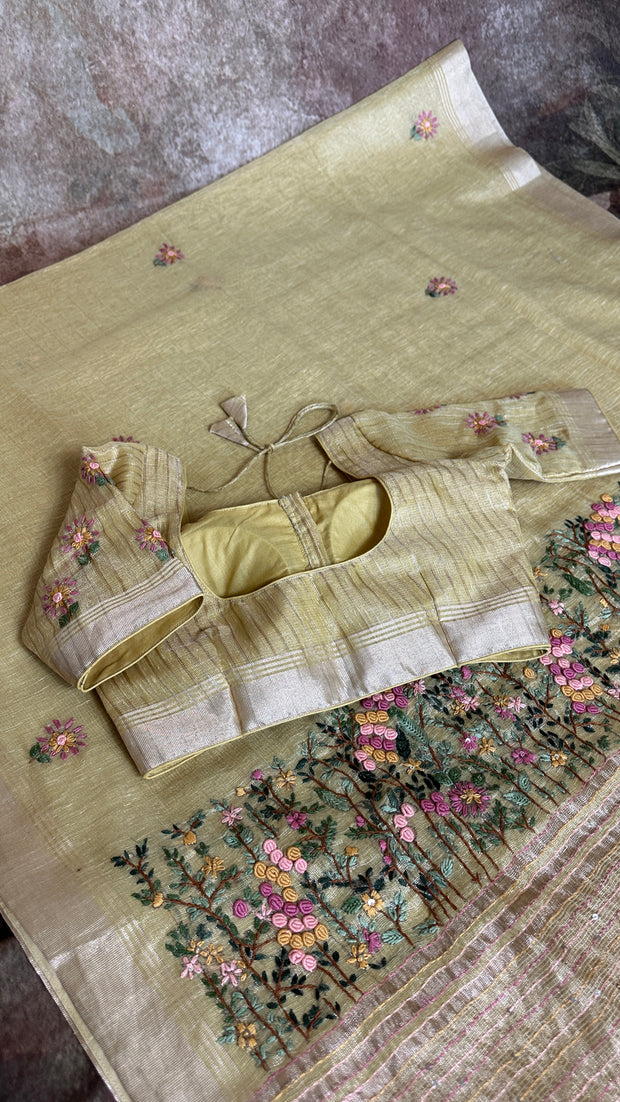 Yellow tissue linen saree with hand emroidery and stitched blouse