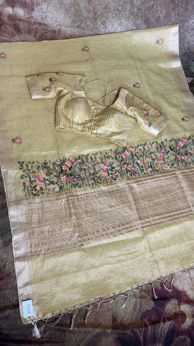 Yellow tissue linen saree with hand emroidery and stitched blouse