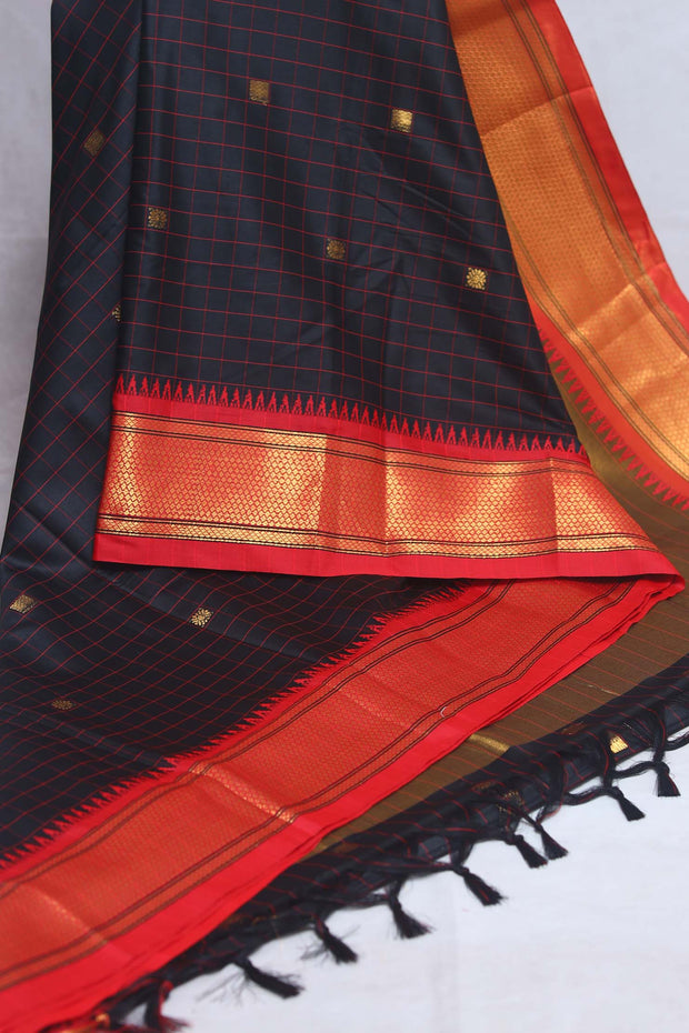 Blackn semi silk saree with orange temple border, with stitched blouse