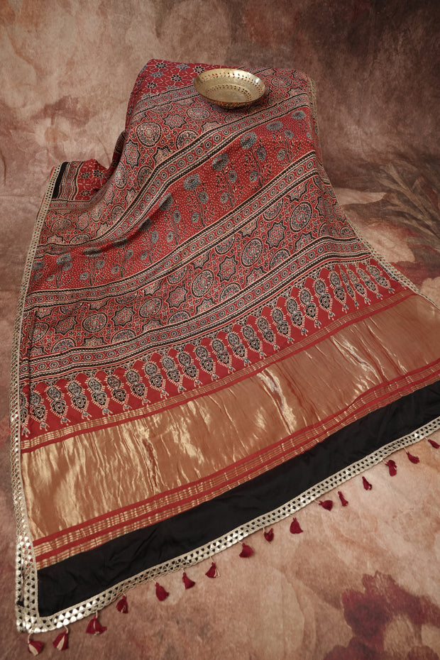 Hand block Ajrakh print Red modal silk saree with gotta patti border, with stitched blouse