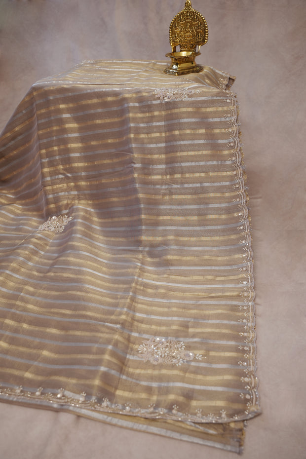 Gold and Silver striped Tissue silk saree with hand embroidery and contrast blouse