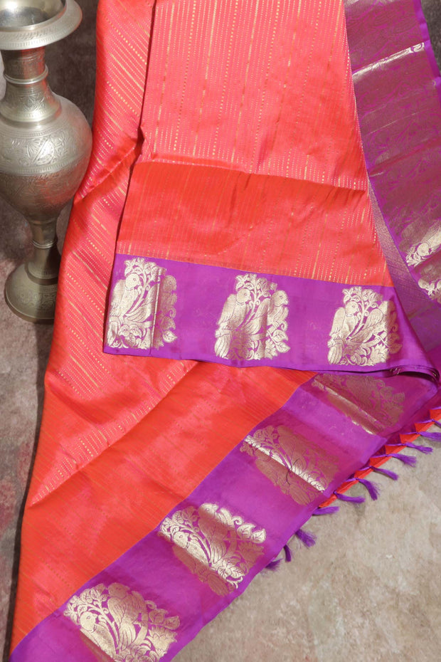 Orange 80/20 Kanchivaram saree with purple border, stitched blouse