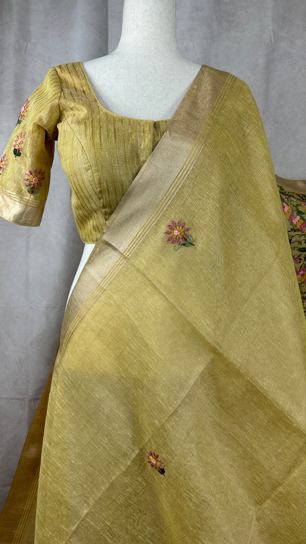 Yellow tissue linen saree with hand emroidery and stitched blouse