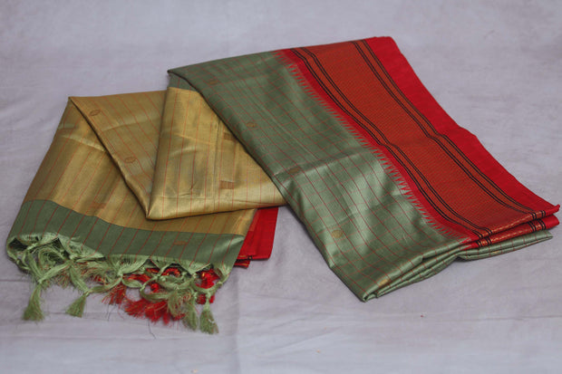 Light green semi silk saree with orange temple border, with stitched blouse