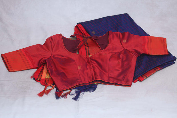 Navy blue semi silk saree with orange temple border, with stitched blouse