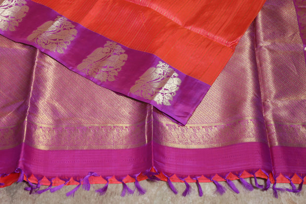 Orange 80/20 Kanchivaram saree with purple border, stitched blouse