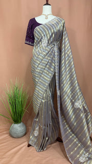 Gold and Silver striped Tissue silk saree with hand embroidery and contrast blouse