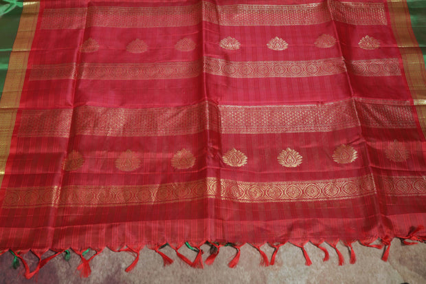 Light green and orange Kanchivaram saree with purple border, stitched blouse