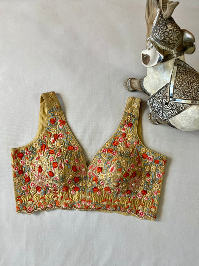 Golden color sleeveless blouse with stone and bead work