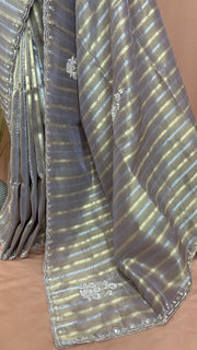 Gold and Silver striped Tissue silk saree with hand embroidery and contrast blouse