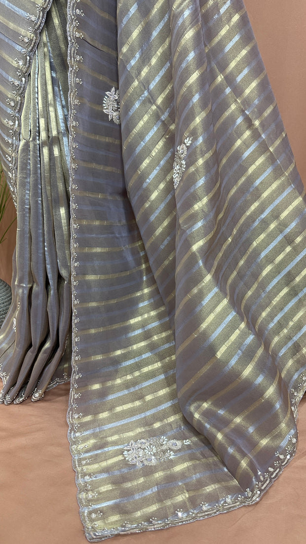 Gold and Silver striped Tissue silk saree with hand embroidery and contrast blouse