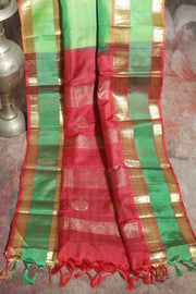 Light green and orange Kanchivaram saree with purple border, stitched blouse