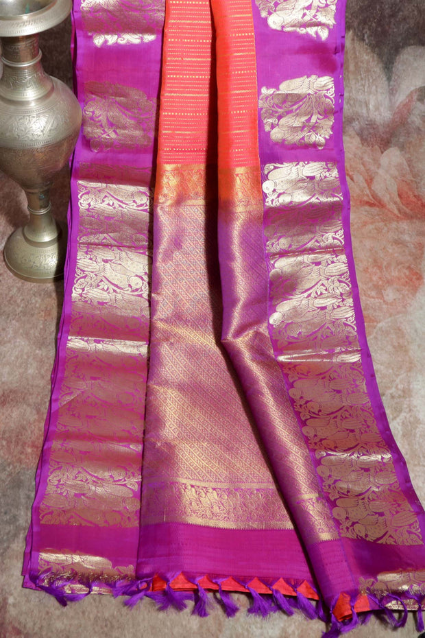 Orange 80/20 Kanchivaram saree with purple border, stitched blouse