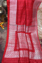 Brick red pure tussar silk handloom saree with silver zari, stitched blouse