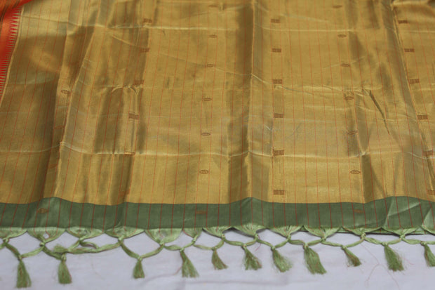 Light green semi silk saree with orange temple border, with stitched blouse