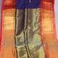 Navy blue semi silk saree with orange temple border, with stitched blouse