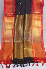 Blackn semi silk saree with orange temple border, with stitched blouse