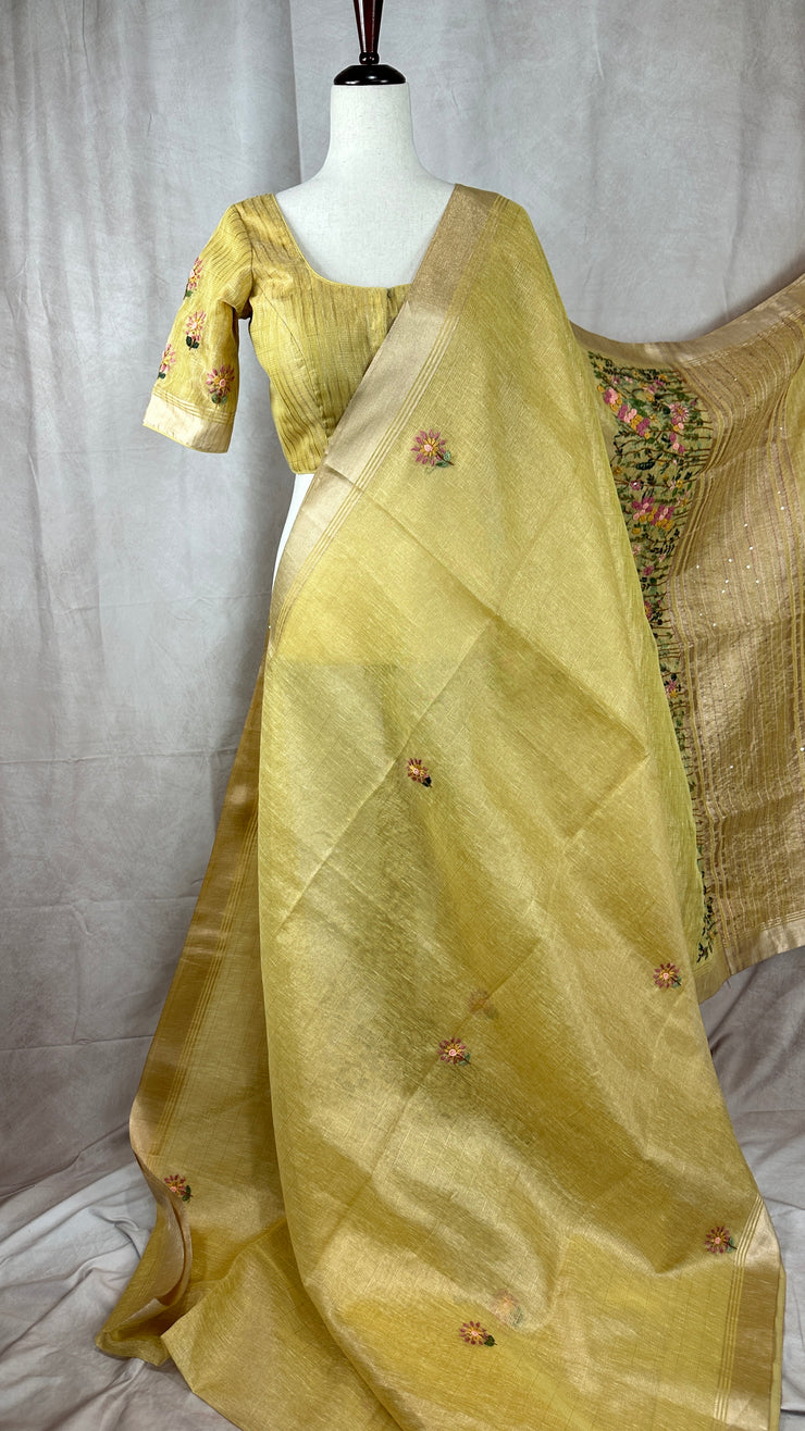 Yellow tissue linen saree with hand emroidery and stitched blouse