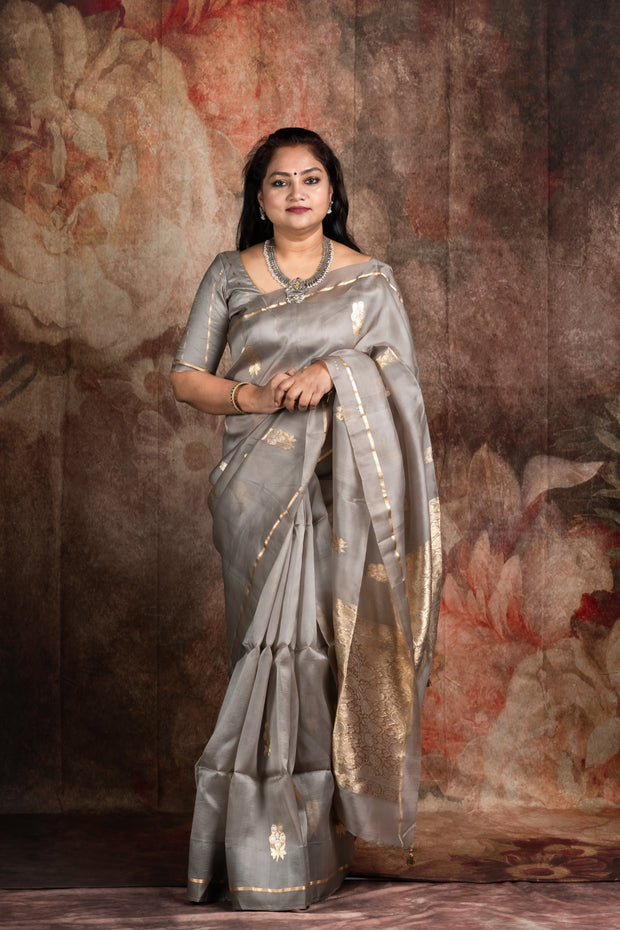 Hand woven Grey Kora Banarsi saree with silver and gold zari stitched blouse