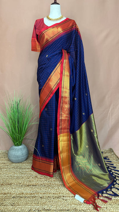 Navy blue semi silk saree with orange temple border, with stitched blouse