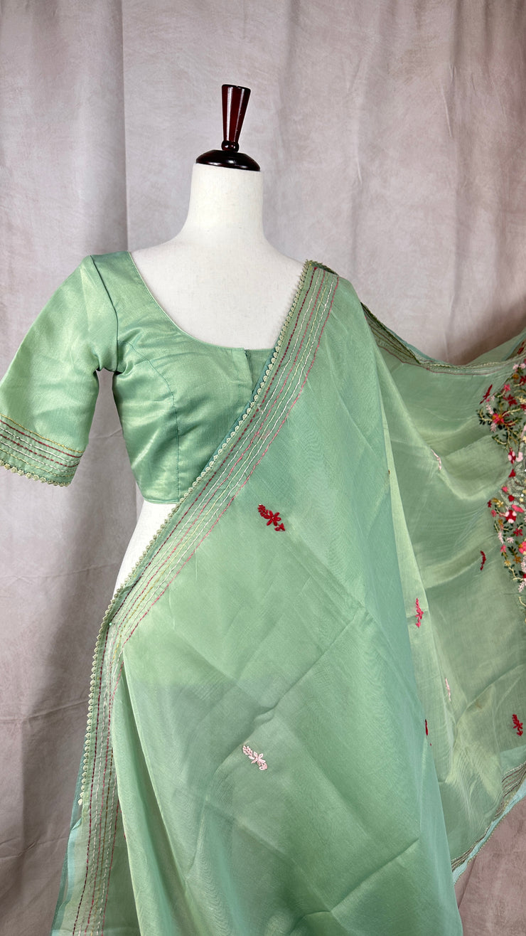 Light sea green tissue linen saree with hand emroidery and stitched blouse