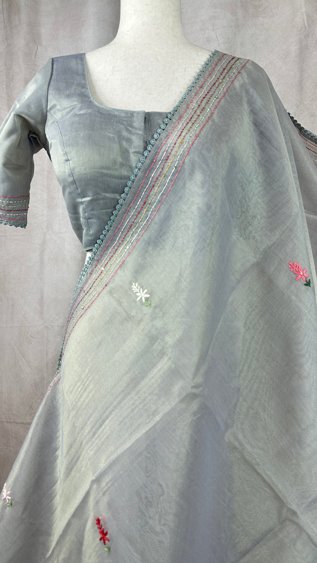 Grey tissue linen saree with hand emroidery and stitched blouse