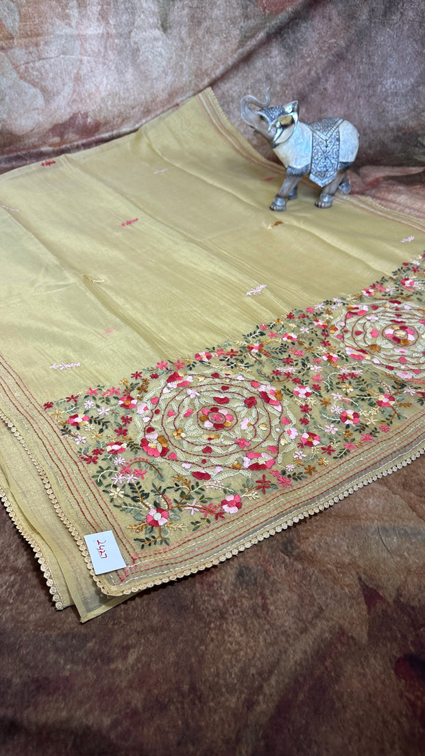 Light yellow tissue linen saree with hand emroidery and stitched blouse