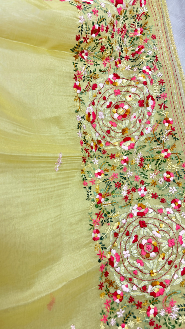 Light yellow tissue linen saree with hand emroidery and stitched blouse