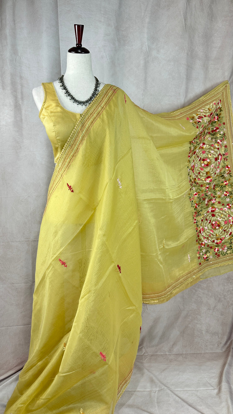 Light yellow tissue linen saree with hand emroidery and stitched blouse