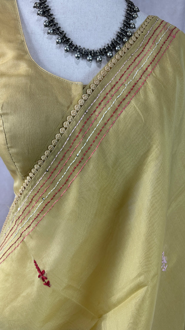 Light yellow tissue linen saree with hand emroidery and stitched blouse